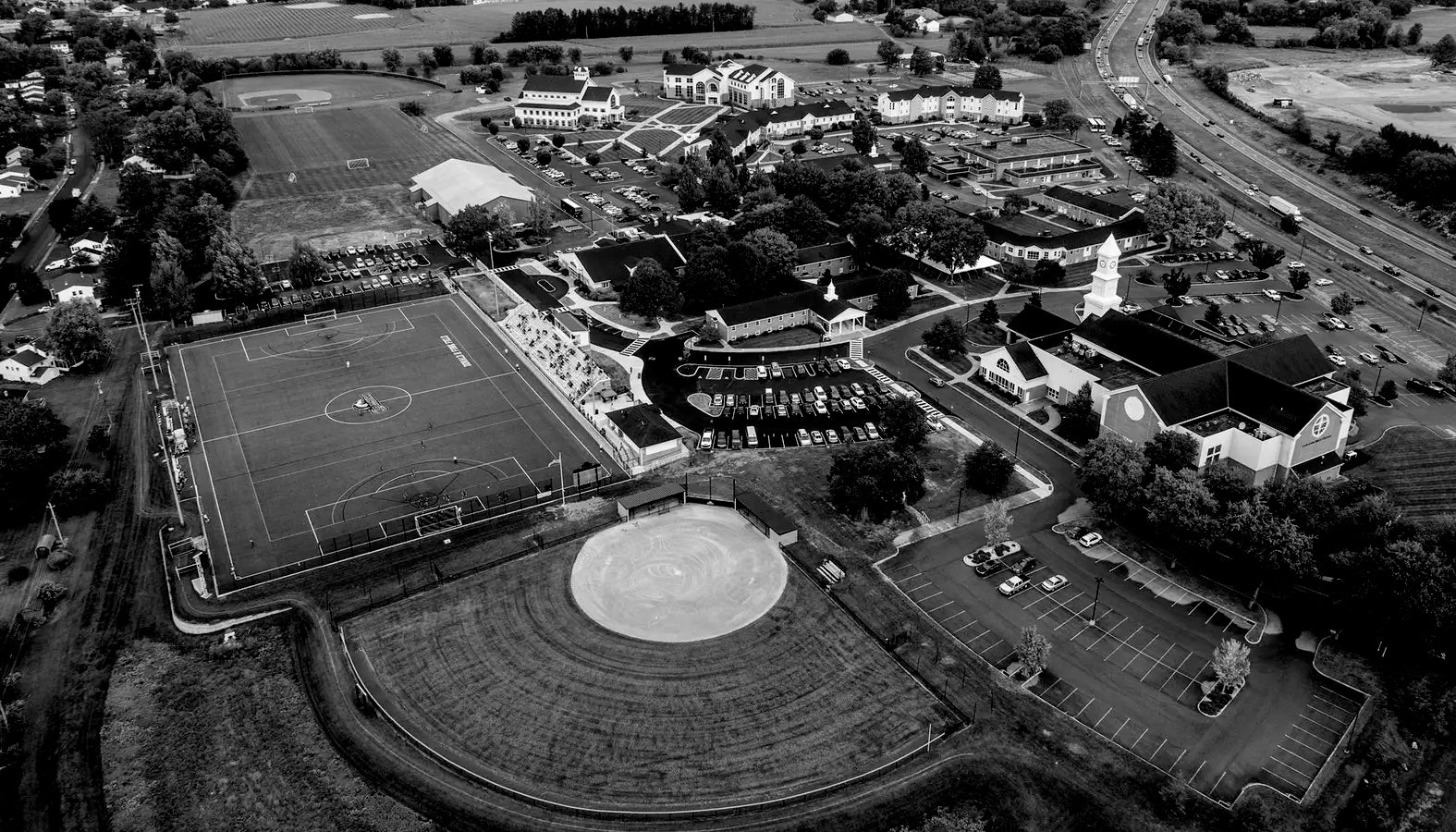 Aerial view of LBC campus with sports fields and buildings.